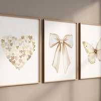 Beige gold wall art set with heart, bow, and butterfly prints. Neutral nursery, modern decor for bedroom, nursery, girls room, teen room