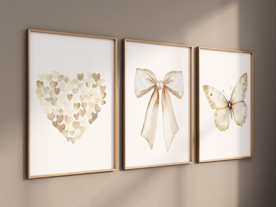 Beige gold wall art set with heart, bow, and butterfly prints. Neutral nursery, modern decor for bedroom, nursery, girls room, teen room
