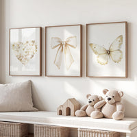 Beige gold wall art set with heart, bow, and butterfly prints. Neutral nursery, modern decor for bedroom, nursery, girls room, teen room